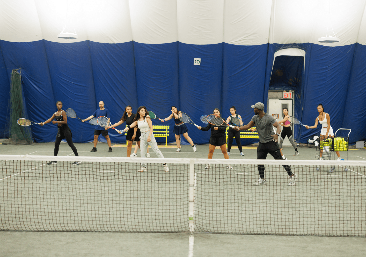 Group class playing tennis